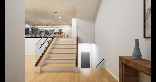 stairway featuring wood-type flooring