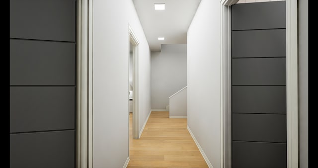 corridor with light hardwood / wood-style floors