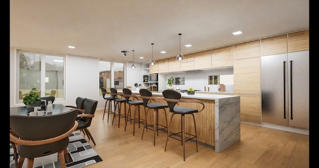 kitchen featuring pendant lighting, light hardwood / wood-style flooring, and a center island