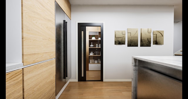 corridor featuring light hardwood / wood-style floors