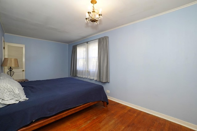 bedroom with an inviting chandelier, ornamental molding, and hardwood / wood-style floors