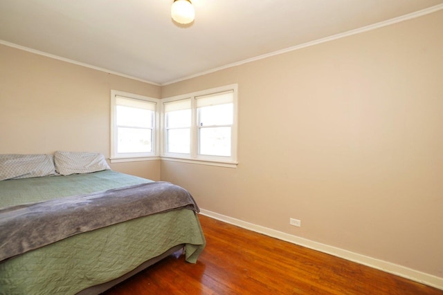 bedroom with wood-type flooring and crown molding