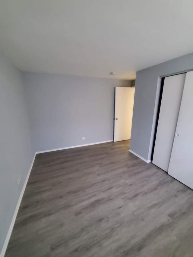 unfurnished bedroom featuring light wood-type flooring and a closet