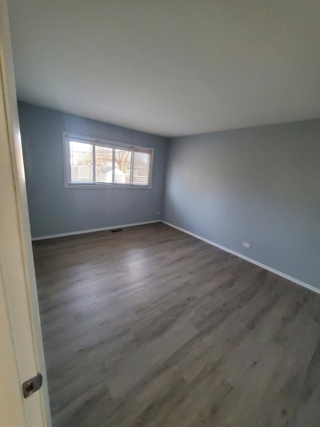 unfurnished room featuring dark hardwood / wood-style flooring