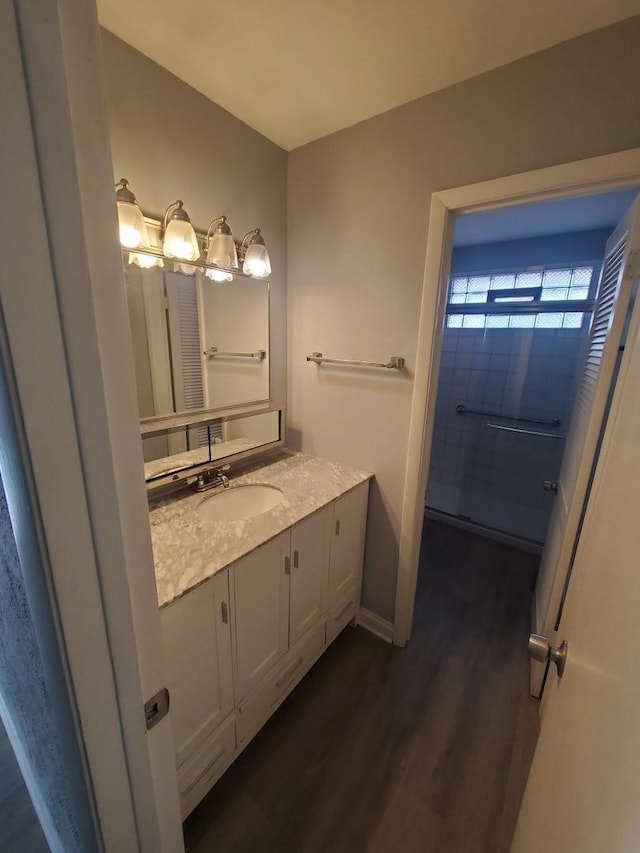 bathroom featuring hardwood / wood-style flooring and vanity