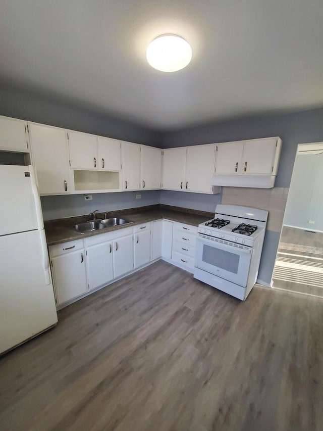 kitchen featuring hardwood / wood-style flooring, sink, white appliances, and white cabinets