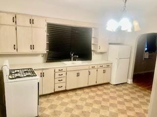 kitchen featuring white appliances and sink