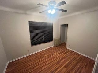 empty room featuring dark hardwood / wood-style flooring and ceiling fan