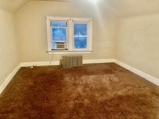 bonus room featuring lofted ceiling, carpet flooring, radiator heating unit, and cooling unit