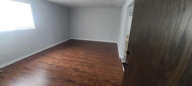 empty room featuring dark wood-type flooring