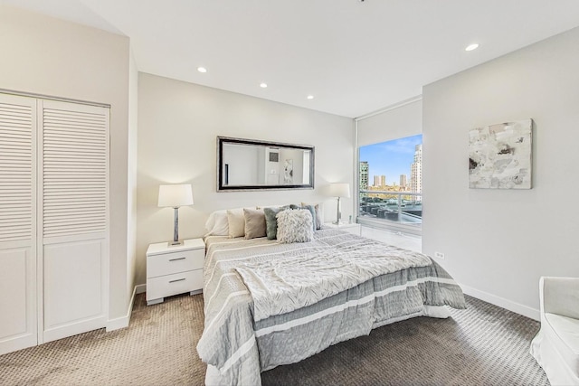 bedroom with light carpet and a closet