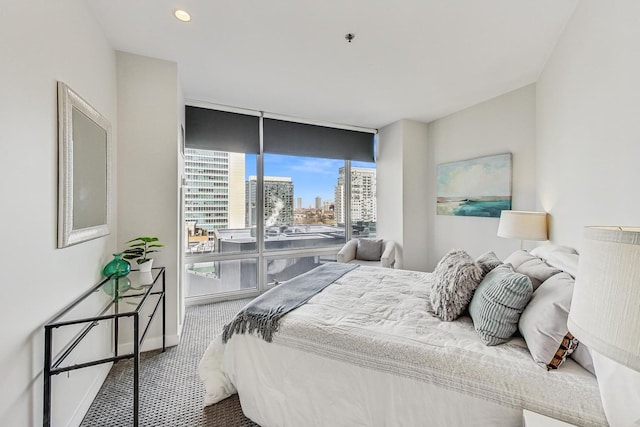 carpeted bedroom featuring expansive windows