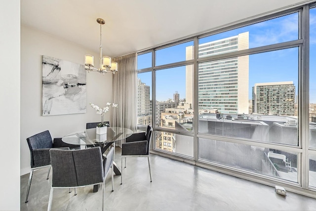 dining area with concrete flooring, floor to ceiling windows, and a chandelier