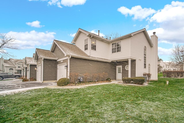 front of property with a garage and a front lawn