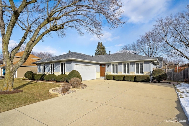 ranch-style home featuring a garage and a front lawn