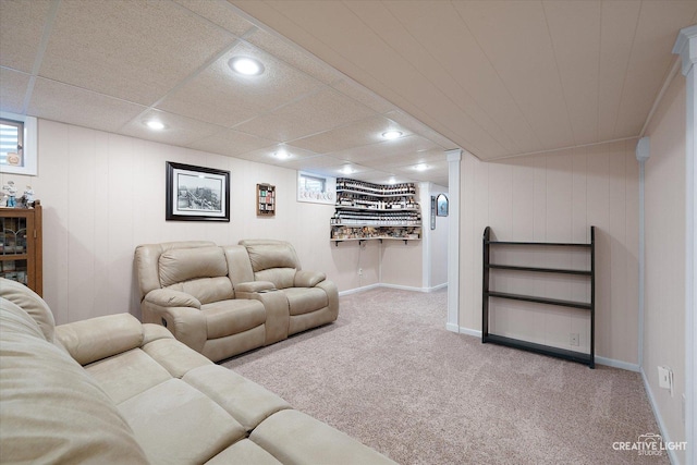 carpeted living room with a paneled ceiling