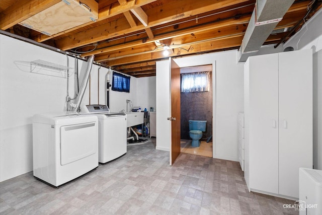 laundry room with washing machine and clothes dryer and sink