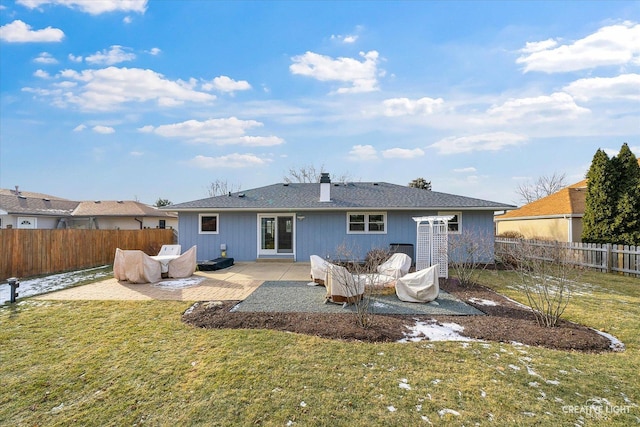 rear view of house with a yard and a patio