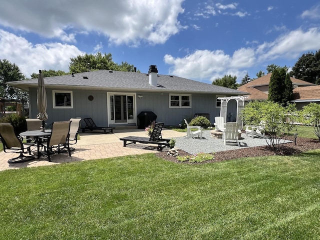 rear view of property featuring a patio area and a yard