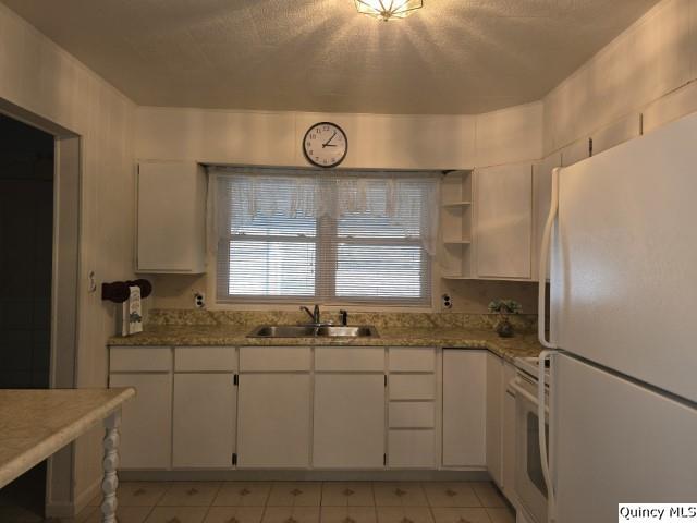 kitchen with sink, white appliances, and white cabinets