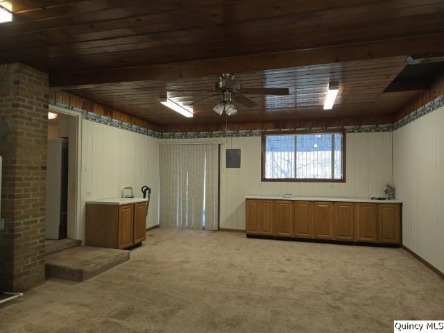 basement featuring wood ceiling, ceiling fan, and light carpet