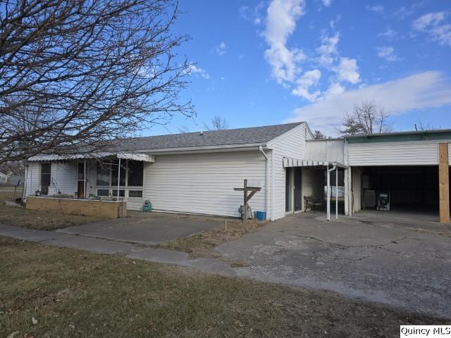 exterior space with a carport and a garage