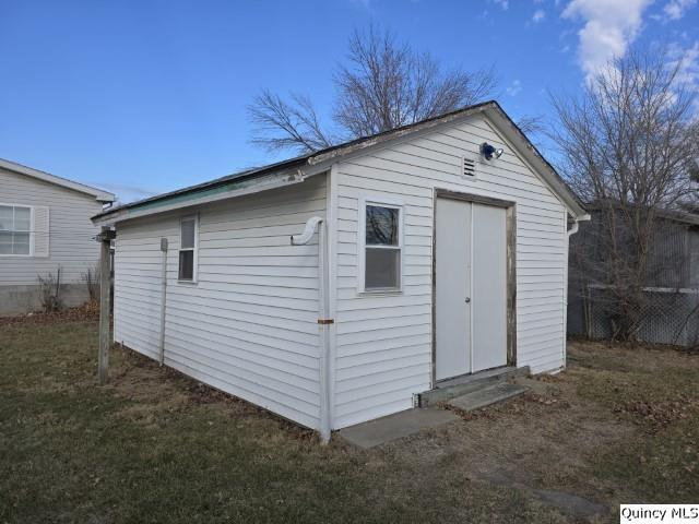 view of outdoor structure with a lawn