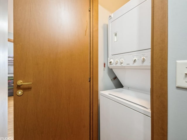 laundry area with stacked washer and dryer