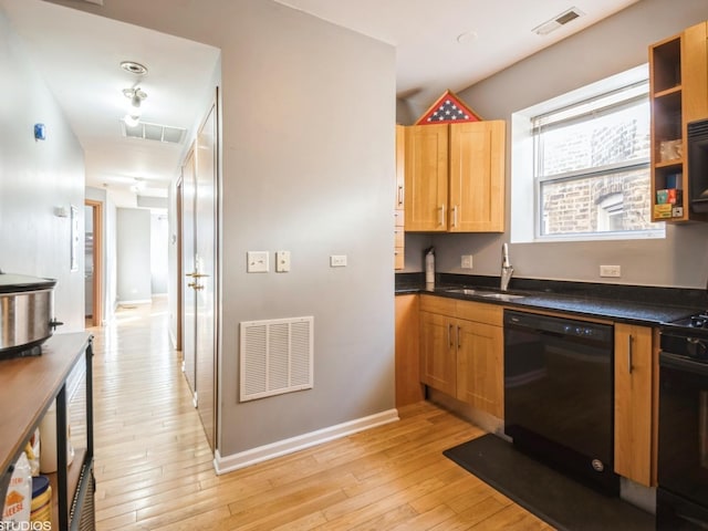 kitchen with black dishwasher, sink, light hardwood / wood-style flooring, and stove