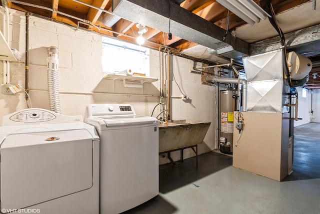 washroom featuring independent washer and dryer, sink, and gas water heater