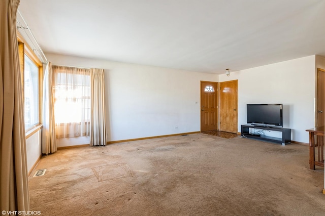 unfurnished living room featuring light carpet