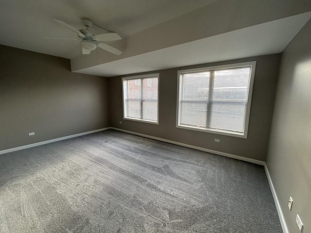 empty room featuring carpet floors and ceiling fan