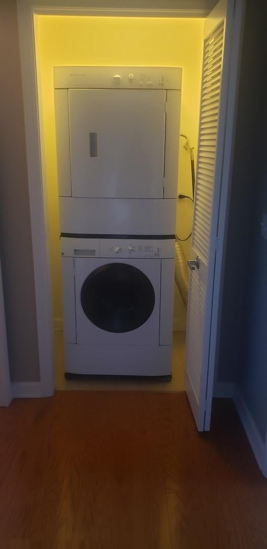 washroom featuring stacked washer / dryer