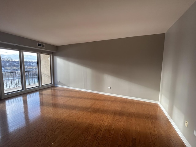 unfurnished room with wood-type flooring