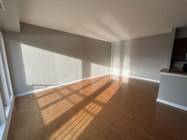 unfurnished living room featuring dark wood-type flooring