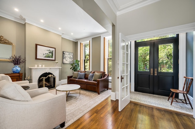 living room featuring dark wood-type flooring, ornamental molding, and french doors