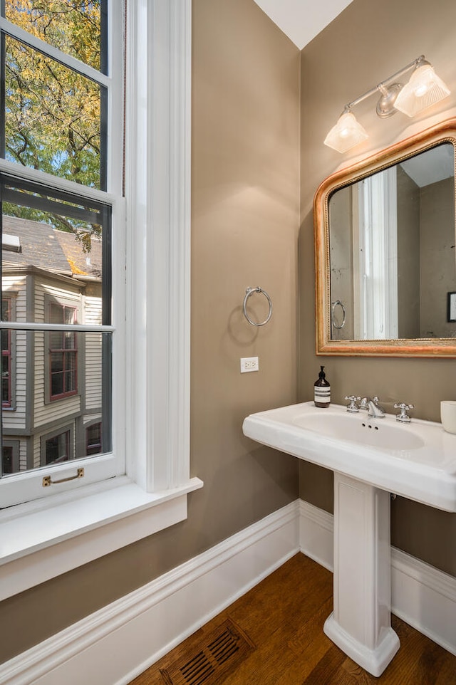 bathroom with hardwood / wood-style floors