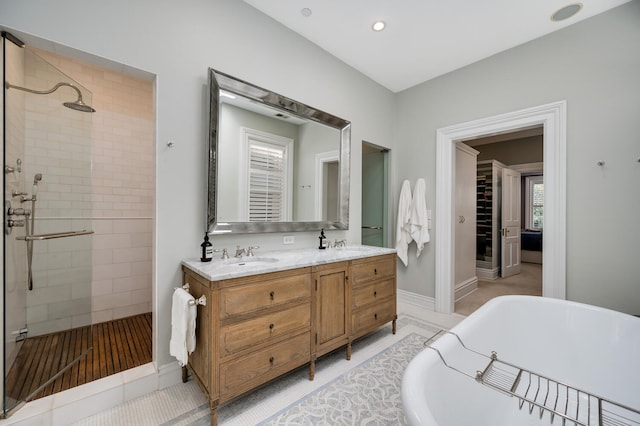 bathroom with plus walk in shower, vanity, and tile patterned flooring