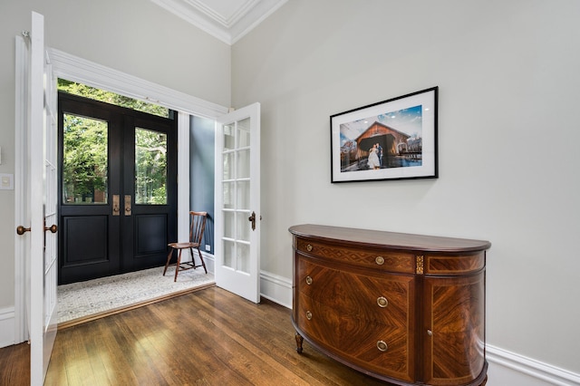 entryway with dark hardwood / wood-style flooring, crown molding, and french doors