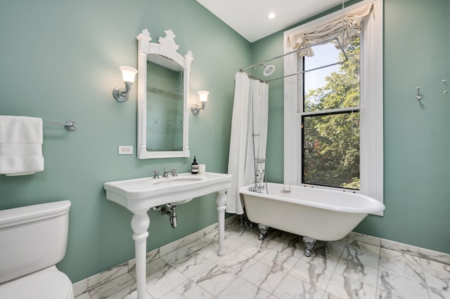 bathroom featuring toilet and separate shower and tub