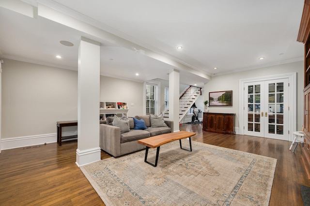 living room with dark hardwood / wood-style floors, crown molding, and french doors