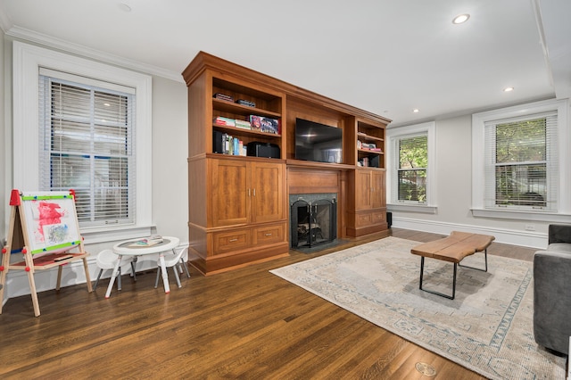 living room featuring dark hardwood / wood-style flooring and ornamental molding