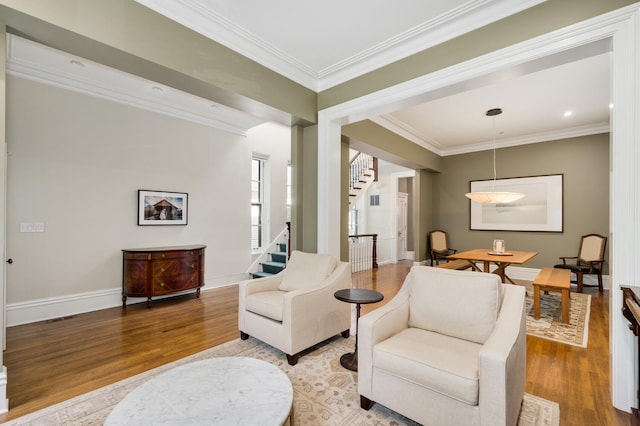 sitting room featuring wood-type flooring and ornamental molding