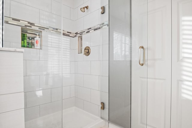 bathroom featuring a shower with door