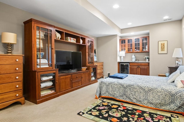 carpeted bedroom featuring wine cooler and bar