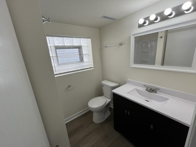 bathroom featuring hardwood / wood-style floors, toilet, and vanity