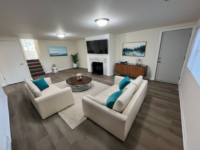 living room with dark hardwood / wood-style floors and a fireplace