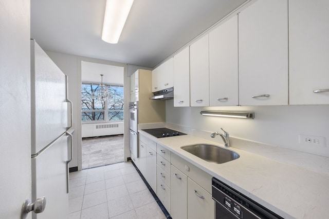 kitchen with decorative light fixtures, white cabinetry, sink, and black appliances