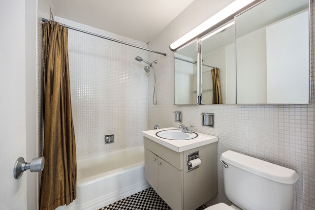 full bathroom with tile walls, tile patterned flooring, vanity, shower / tub combo, and toilet