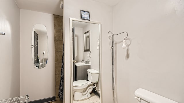 bathroom with toilet and tile patterned floors